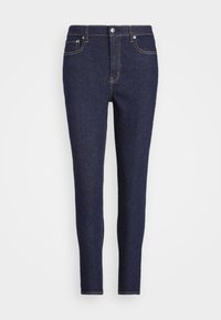 Tmavě modré džíny s úzkým střihem, designem se pěti kapsami a zlatým prošíváním podél švů a kapes. Standardní zapínání na knoflík.