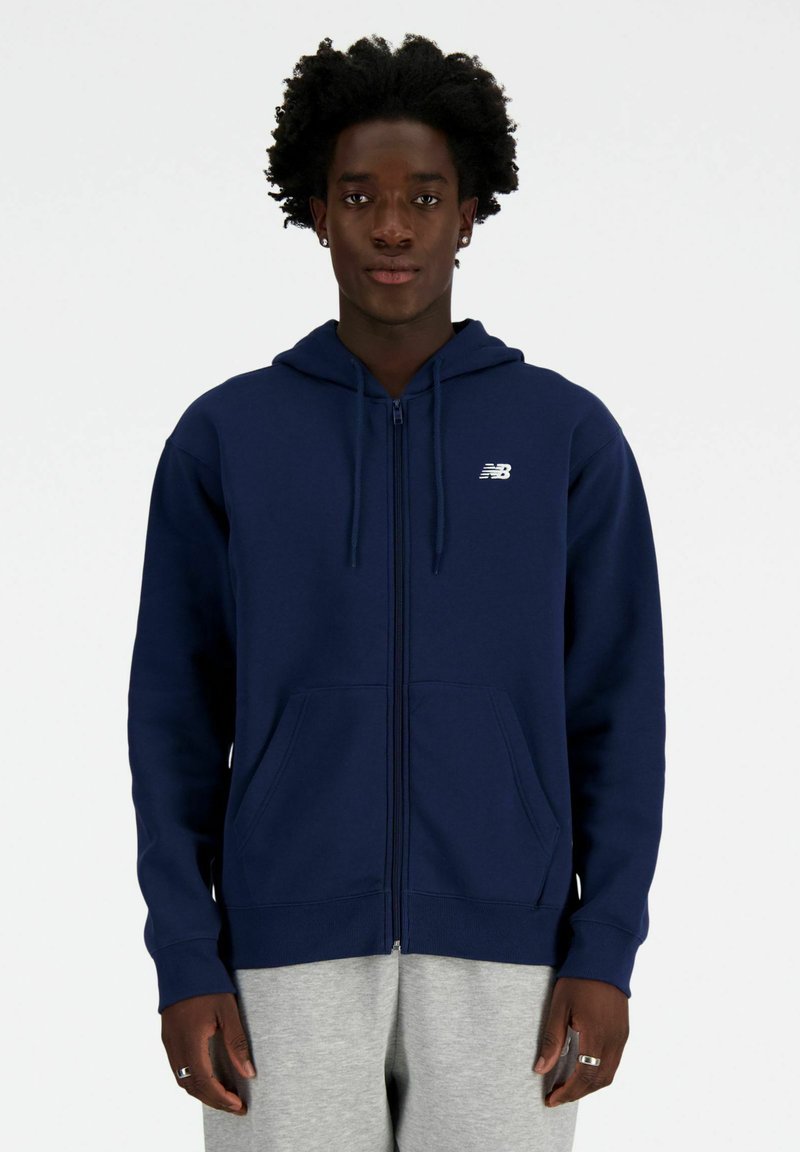 Navy zip-up hoodie made of cotton blend, featuring a drawstring hood, front pockets, and a small white logo on the left chest.
