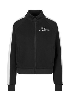 Černá zipová sportovní bunda se znakem Kani vyšívaným na levé straně hrudi, bílými pruhy na rukávech a žebrovanými manžetami a lemem.