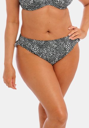 Mustavalkoinen pilkkubikini, jossa on muotoiltu yläosa ja korkea vyötärö alaosa, jossa on röyhelösivuvaihtoehdot ja pehmeä kangaskuvio.