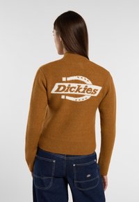 Brown knitted sweater with a high collar, featuring a white logo "Dickies" on the back and ribbed hem and sleeve cuffs.