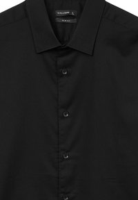 Schwarzes Slim-Fit-Hemd aus strukturiertem Stoff, mit Kentkragen und fünf Knöpfen auf der Vorderseite. Das Etikett trägt "CALLIOPE", Größe L.