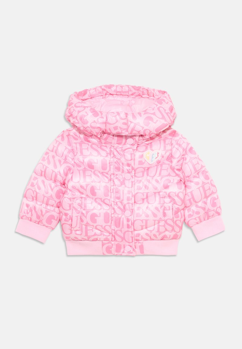 Pink puffer jacket with hood and elastic cuffs, featuring repeated "GUESS" logo patterns and a small heart patch on the chest.