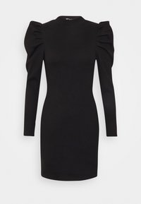 Svart ribbad stickad klänning med långa puffärmar och hög urringning, figurnära silhuett, knälång fåll.