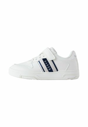 White athletic shoe with a textured leather upper, navy stripes, and a Velcro strap, featuring a rubber sole and round toe design.