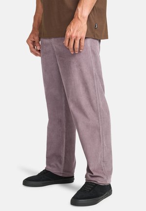 Corduroy pants in lavender, featuring a straight leg design, textured fabric, and subtle vertical ribbing. Paired with black sneakers.