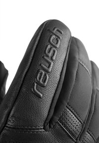 Schwarze Lederhandschuhe mit einem strukturierten Design, genähten Akzenten und geprägtem Branding. Das Material wirkt strapazierfähig und bietet eine enge Passform.