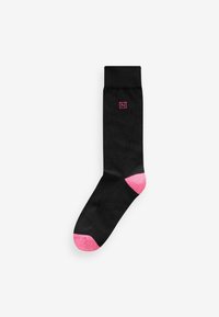 Black sock with pink accents at the toe and heel. Smooth texture with a small logo near the top in matching pink.