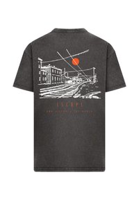 Black cotton t-shirt featuring a white line drawing of a street scene with a red sun and the text "ESCAPE AND DISCOVER YOUR WORLD."
