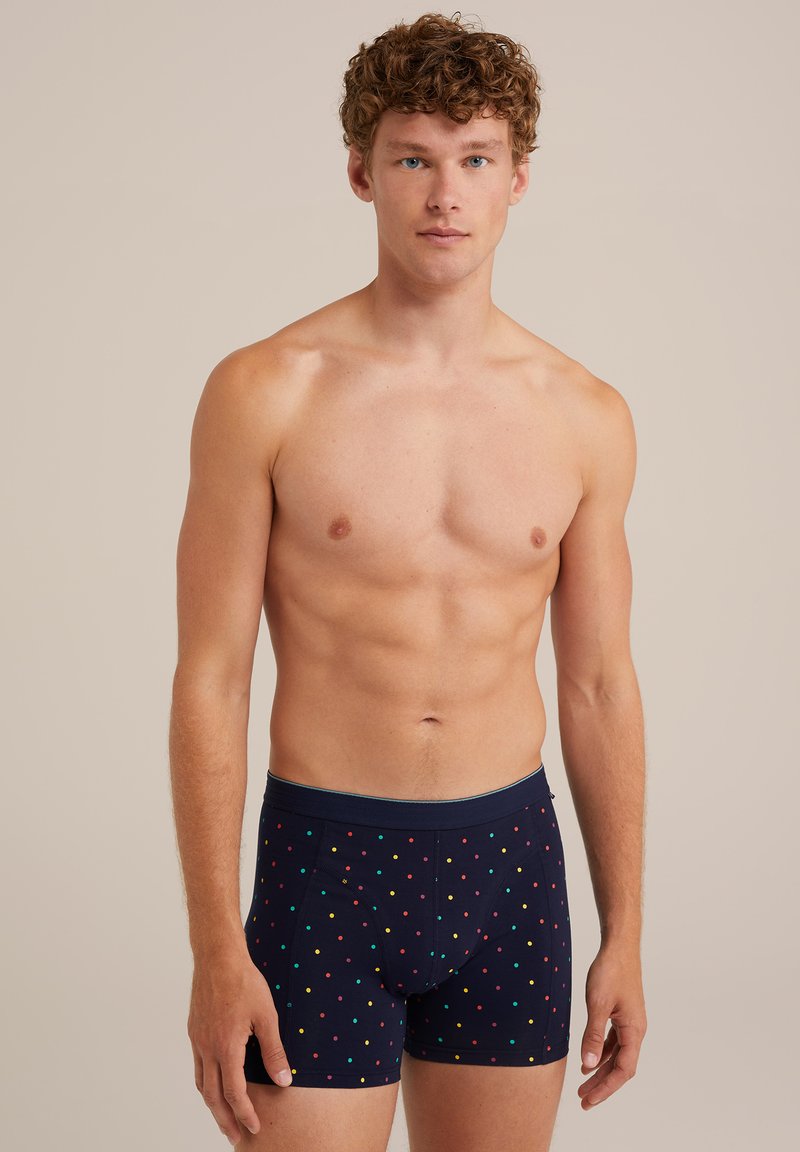 Tengerész kék boxer alsónemű, sokszínű pöttyökkel, puha anyagból készült, testhez álló kialakítással és kényelmes, rugalmas derékkal.