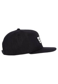 Cappellino nero con visiera piatta, caratterizzato da un'etichetta rettangolare bianca sulla parte anteriore. Realizzato in tessuto, ha un design aderente senza decorazioni visibili.