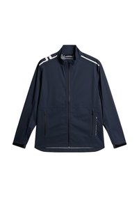 Marinblå jacka i lätt material med hög krage, två dragkedjefickor och reflekterande vita detaljer på axlarna.