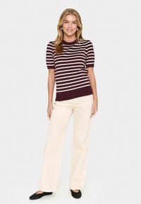 Maroon and cream striped short-sleeve knit top paired with wide cream pants and black flats. The design features a crew neck and textured fabric.