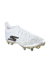 Vit fotbollssko med ett crackat guldmönster och svarta accenter. Utrustad med en texturerad yta och sex metallspikar för grepp.