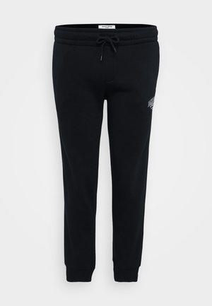 Zwarte sweatpants van zacht materiaal, met een elastische tailleband, een trekkoord, zijzakken en een klein logo op de heup.