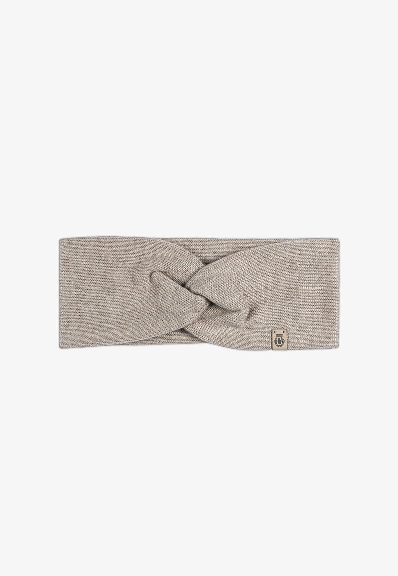 Knit headband in a light beige color with a twisted design at the front and a small branded tag on the side. Smooth texture.