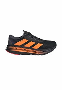 Running shoe with a black mesh upper, orange accents, three horizontal stripes, cushioned sole, and a textured outsole for grip.