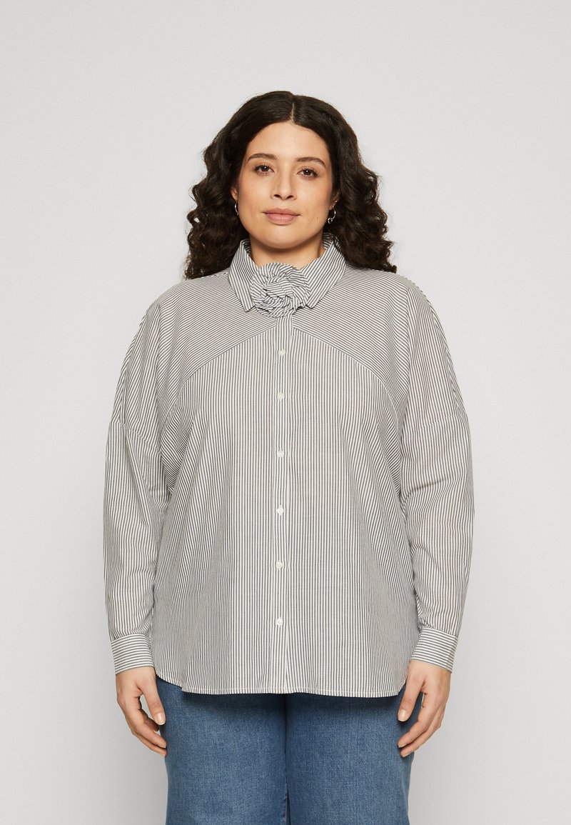 Striped blouse with a mock collar, button closure, and dropped shoulder seams. Material has a smooth texture in monochrome colors.