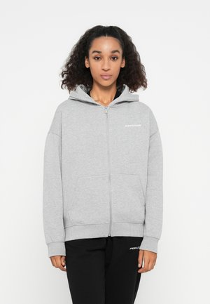 Gray zip-up hoodie made from soft fabric, featuring a front pocket, ribbed cuffs, and a hood. Displays the brand name in white on the front.