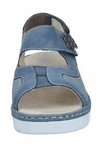 Blue sandal with open toe and heel design. Made of textured material, featuring decorative hardware and contrasting stitching on a white sole.