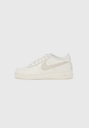 Baskets blanches Nike Air Force 1 avec dessus en cuir, bout rond, détails perforés et accents de ton neutre. Semelle en caoutchouc et col rembourré.