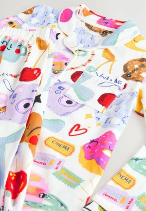 Pigiama in cotone bianco con motivi colorati di volti, snack e oggetti. Include una maglietta con bottoni e pantaloni con vita elastica.