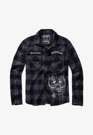 Sort og lilla ternet flannel skjorte med lange ærmer, der har broderede lapper og et grafisk design af et kranie med horn på fronten.