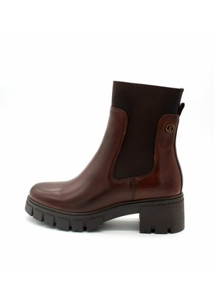 Stivaletto in pelle marrone con pannelli laterali elasticizzati, punta tonda e suola in gomma nera chunky. Presenta un dettaglio logo vicino al tallone.