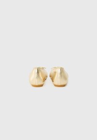 Gold leather ballet flats with a smooth texture, round toe, and a small bow detail at the front. Soft, flexible sole. Classic design.