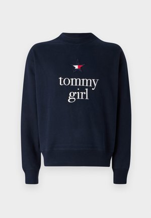 Navy blue sweatshirt with a round neckline, long sleeves, and ribbed cuffs. Features embroidered "tommy girl" text and a star logo.