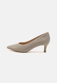 Beige pointed-toe pump with a textured fabric upper, low heel, and smooth inner lining. Sleek design with no visible accents or patterns.
