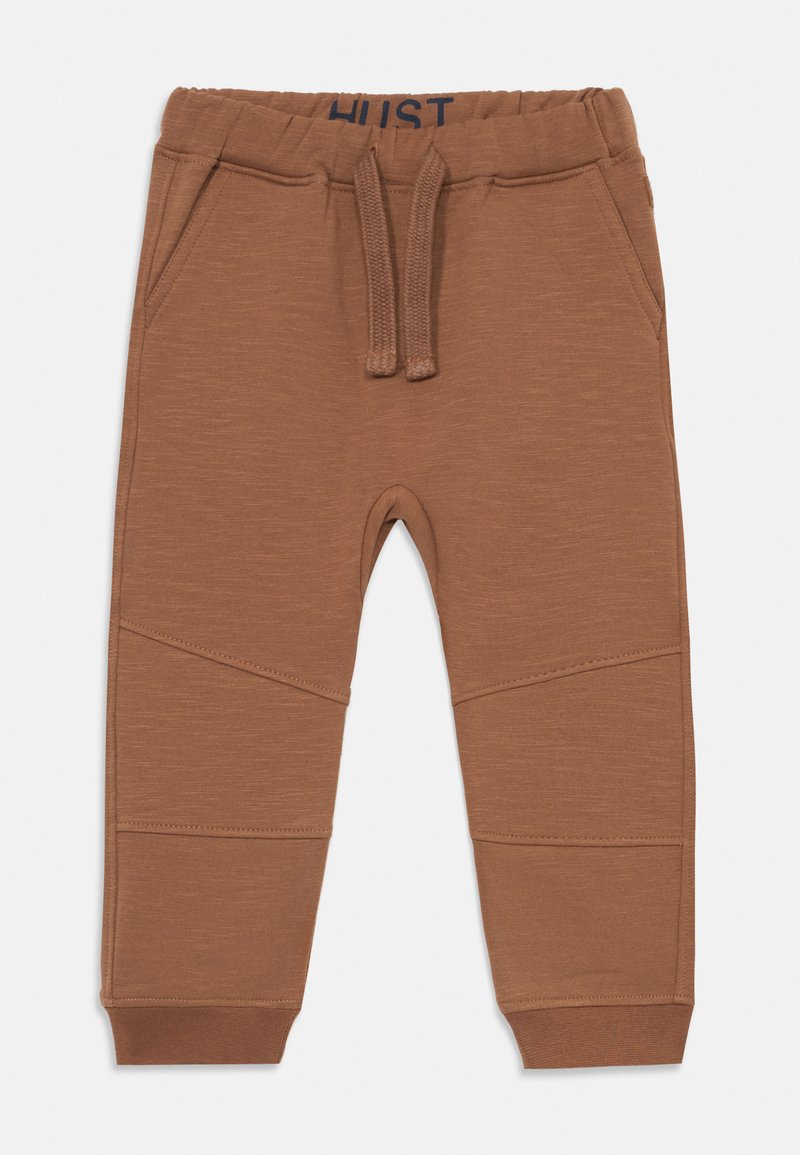 Ruske sweatpantsit, joissa on joustava vyötärö ja nauha, sivutaskut sekä viistot saumat urheilullisen ilmeen saavuttamiseksi.