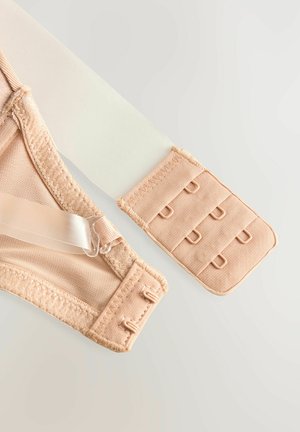 Beige bralette med nätdesign, justerbara axelband och krok-och-öga-stängning. Har mjuka, släta texturer och en sömlös finish.