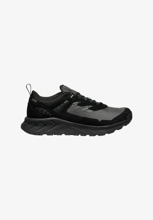 Black and gray hiking shoes with mesh and suede upper, laces, padded collar, and a rugged rubber sole featuring a textured tread pattern.