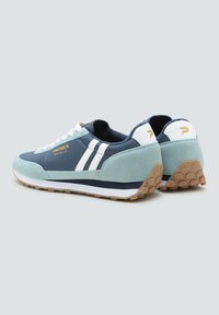 Pair of blue and mint green Patrick Monza sneakers with white stripes, white laces, and textured tan soles on a gray background.