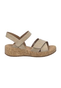 Beige sandaal met open teen, verstelbare bandjes en een kurken plateauzool, ontworpen voor casual gebruik en comfort.