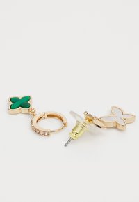 Gold-tone earrings featuring a green enamel butterfly charm and a clear stud with a butterfly design. The hoop includes sparkling accents.