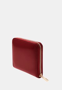 Portafoglio in pelle rossa con finitura lucida, forma rettangolare, zip dorata e zip pull con marchio. Bordi cuciti e texture liscia.