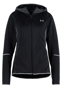 Zwarte zip-up hoodie met textuurstof, reflecterende accenten en zijpanelen. Heeft lange mouwen en een hoge kraag.