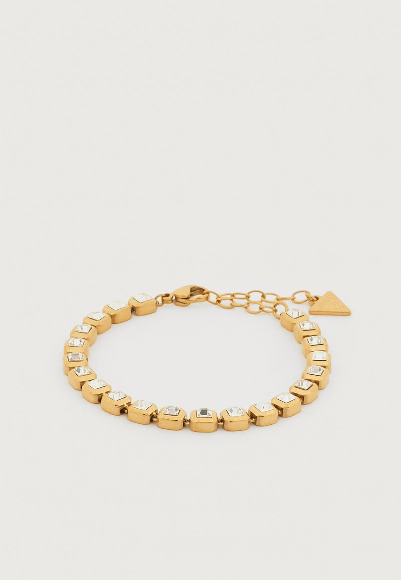 Βραχιόλι σε χρυσή απόχρωση με τετράγωνα διάφανα στρας τοποθετημένα σε ξεχωριστούς κρίκους και κούμπωμα με αστακό, ρυθμιζόμενη αλυσίδα και τριγωνικό μενταγιόν.