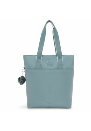 Light blue tote bag made from fabric with two sturdy handles. Features a round logo and a small plush charm attached to a zipper.