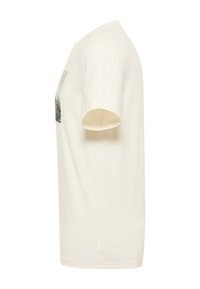 Cream-colored cotton t-shirt with short sleeves, featuring a graphic print on the front and a crew neck design. Smooth texture.