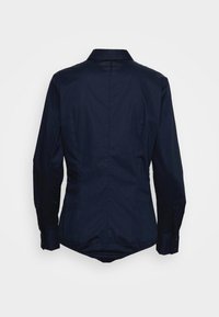 Navy blue long-sleeve shirt with a fitted silhouette, pointed collar, and button closure at the cuffs and hem. Smooth, textured fabric.