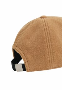 Bruine vilt pet met een ronde kroon, een zwart verstelbaar bandje aan de achterkant en een zilveren metalen accent. Bevat zichtbare stiksels.