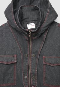 Giacca in denim di colore grigio scuro con cuciture rosse, chiusura con zip e due tasche frontali. Presenta un cappuccio e una finitura testurizzata.