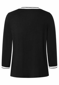 Black long-sleeve top with a round neckline, featuring white accents on cuffs and collar. Smooth texture, casual fit, and simple design.