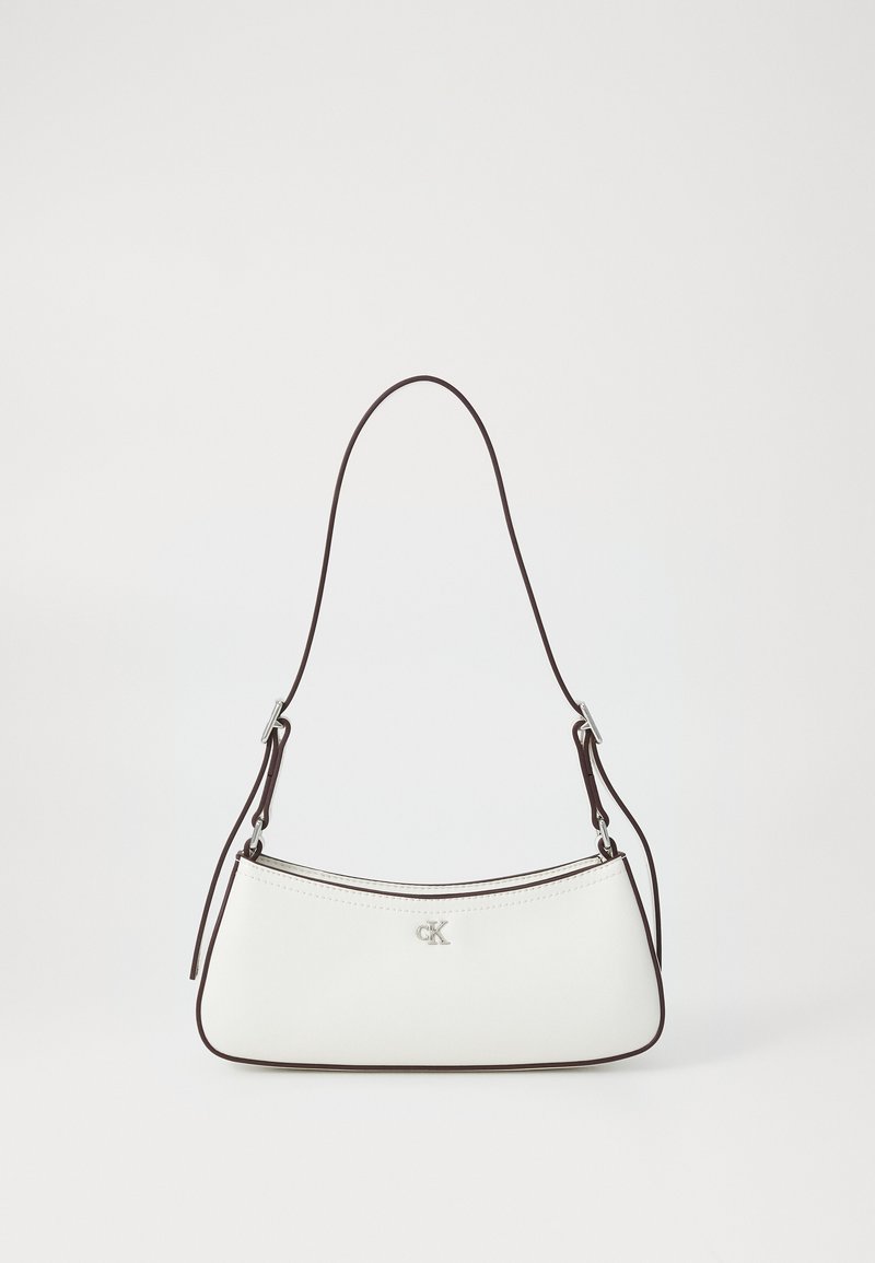 White leather handbag with a curved shape, brown trim, single adjustable shoulder strap, and silver logo detail on the front.