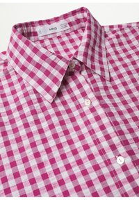Camisa de manga corta en patrón de cuadros rosa y blanco, hecha de una tela ligera, con cuello abotonado y botones blancos.