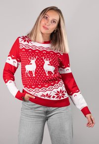 Rot-weißer Pullover mit Rentieren und geometrischen Mustern. Gerippte Bündchen und Saum, weicher Stoff mit einer leicht lockeren Passform.