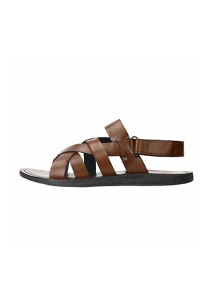 Brown leather sandal featuring crisscrossed straps, an open toe design, and a rear strap with hook-and-loop closure for a secure fit.
